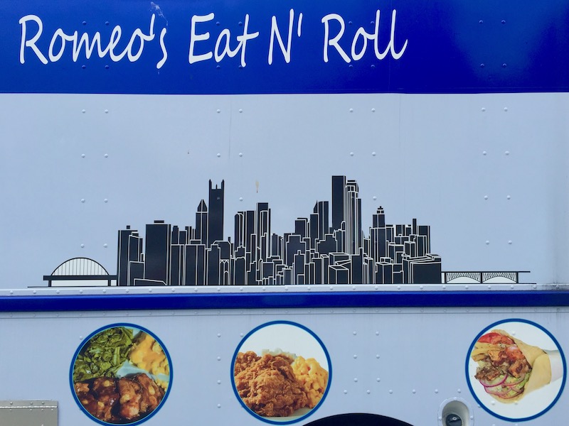 signage for food truck including densely-packed depiction of downtown Pittsburgh buildings