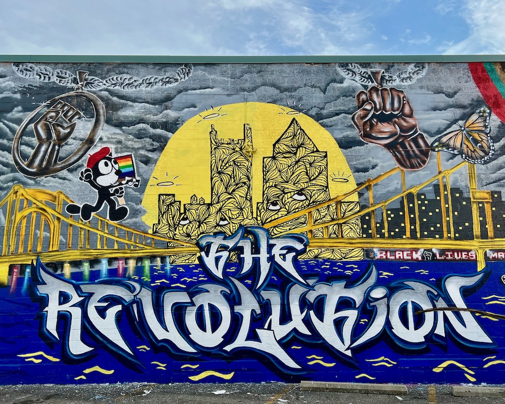 mural depicting yellow bridge and downtown Pittsburgh skyline