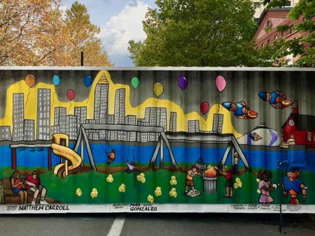 shipping container painted with mural including Pittsburgh skyline