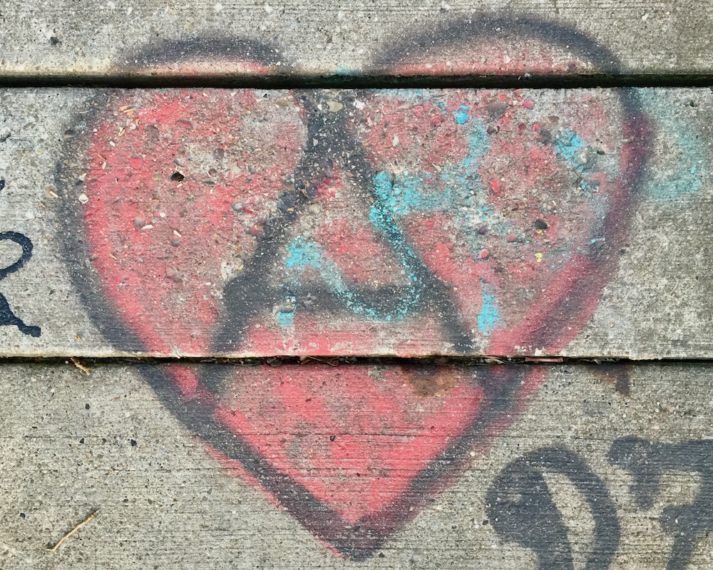 graffiti heart with large letter "A" painted on concrete steps