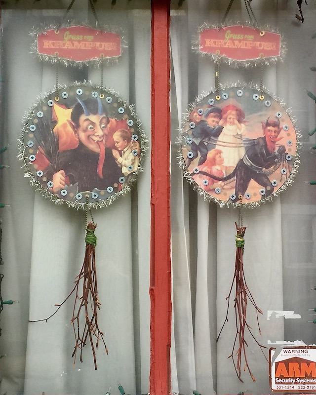 window decorated with two Krampus ornaments