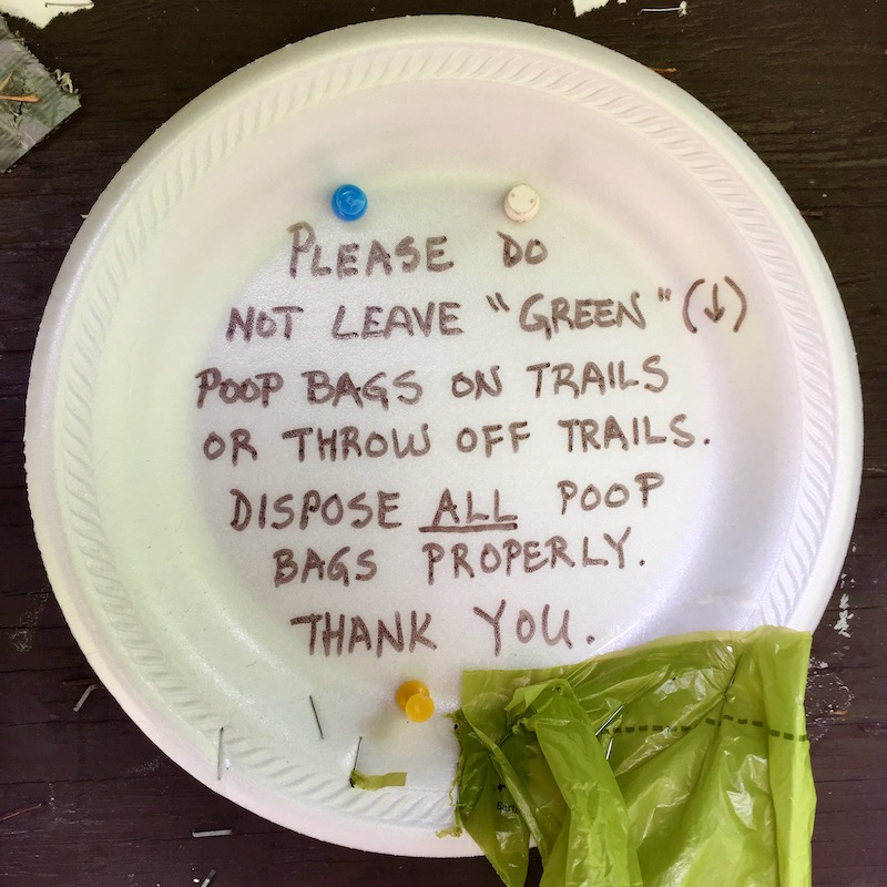 message about dog poop bags use written on styrofoam plate