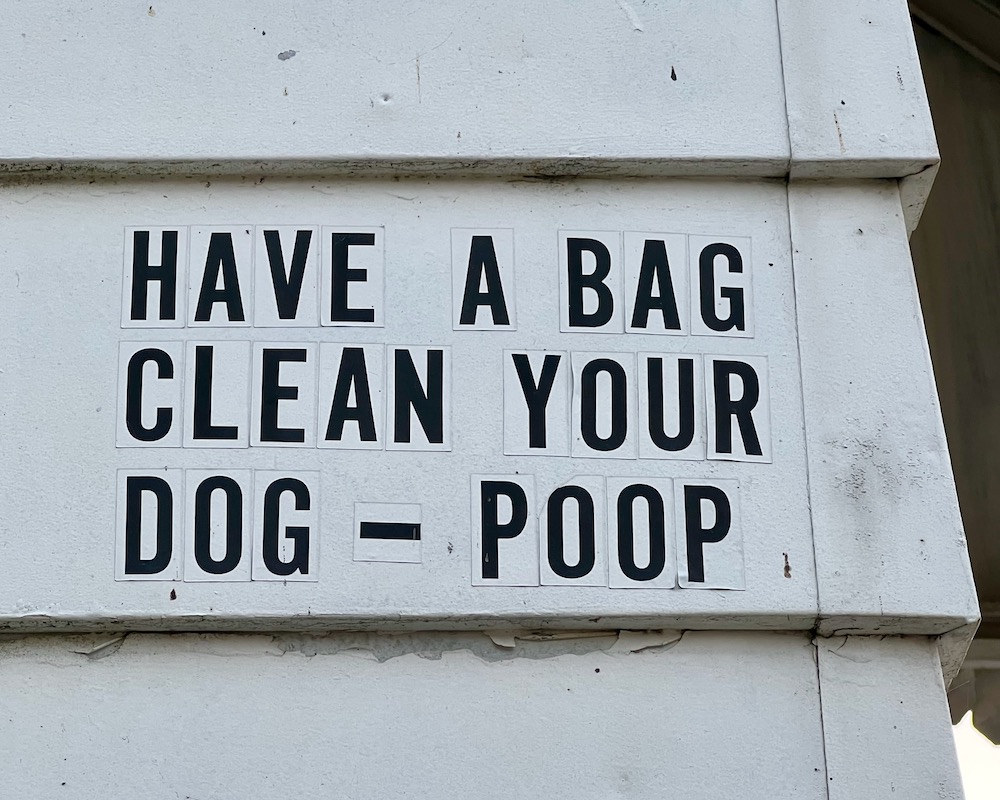 message to clean up doog poop in stickers on side of house