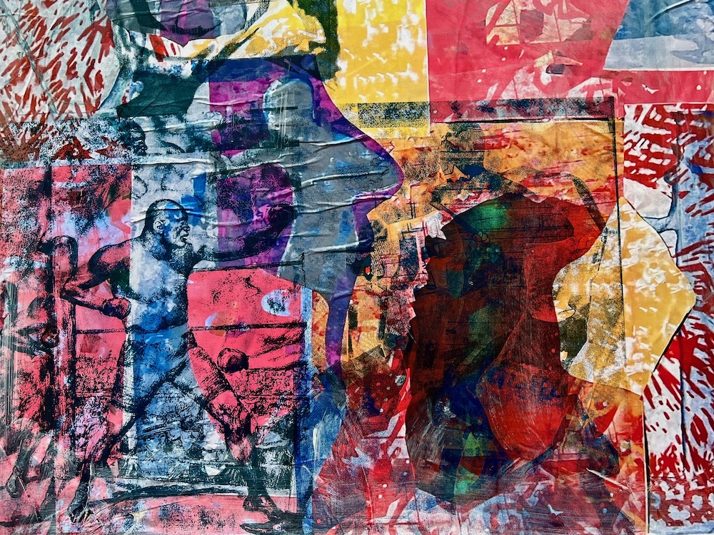 colorful collage of printed paper images layered on plywood covering vacant storefront