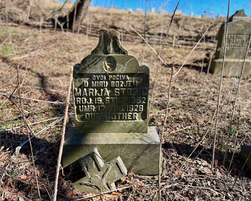 broken grave marker in untended cemetery