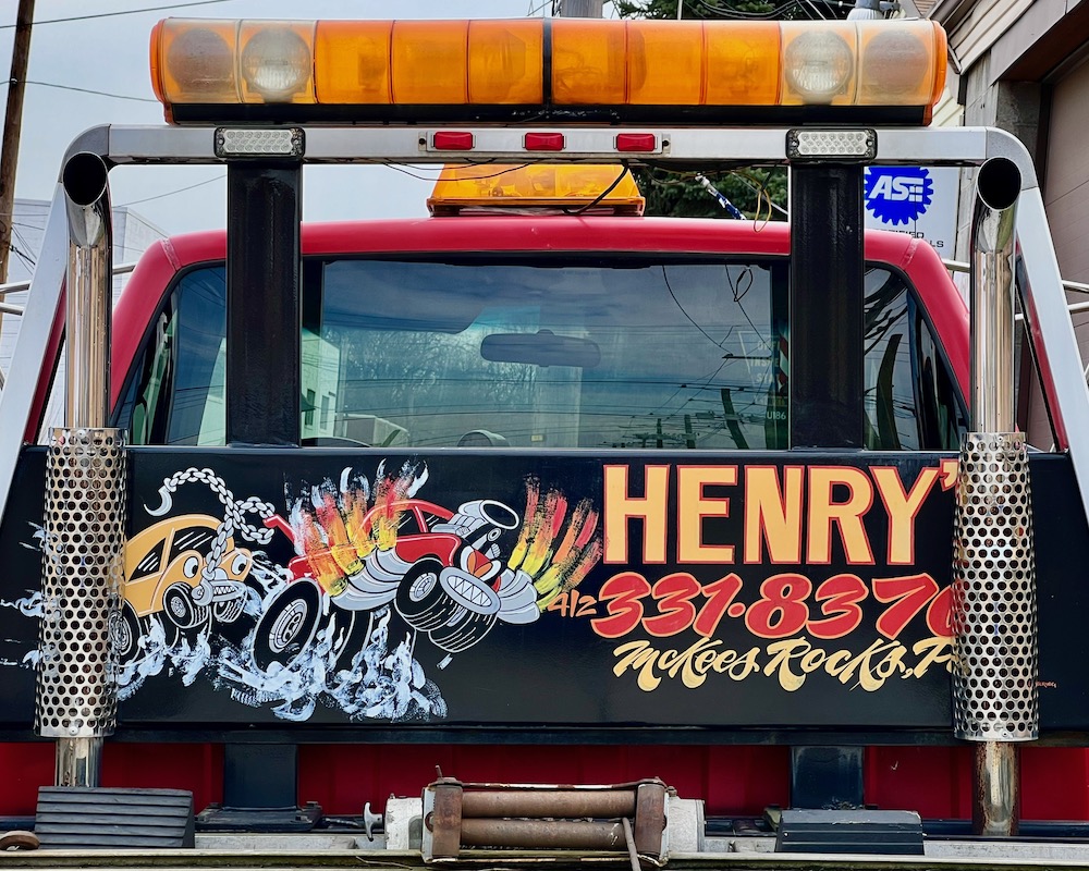 auto tow truck painted with image of cartoon tow truck