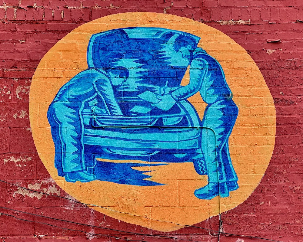 mural for auto repair shop of two mechanics working on car engine