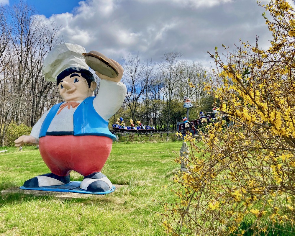 large statue of chef holding a hamburger