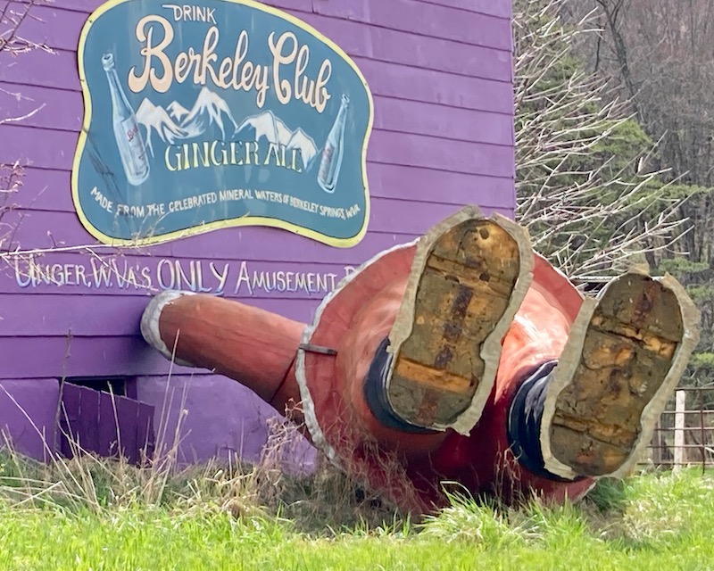 large statue of Santa Clause toppled on his back