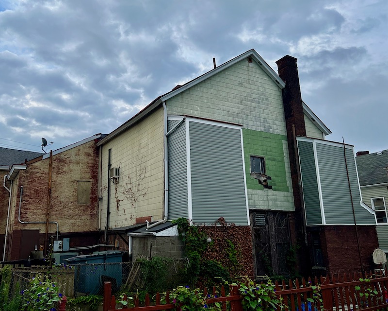 large older building using multiple types of siding