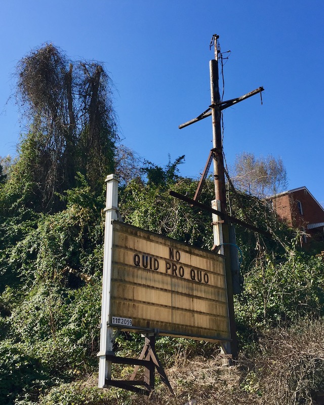 large roadside sign saying "No quid pro quo"