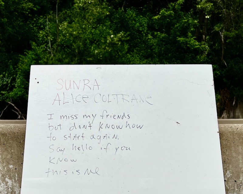 hand-written sign left by highway