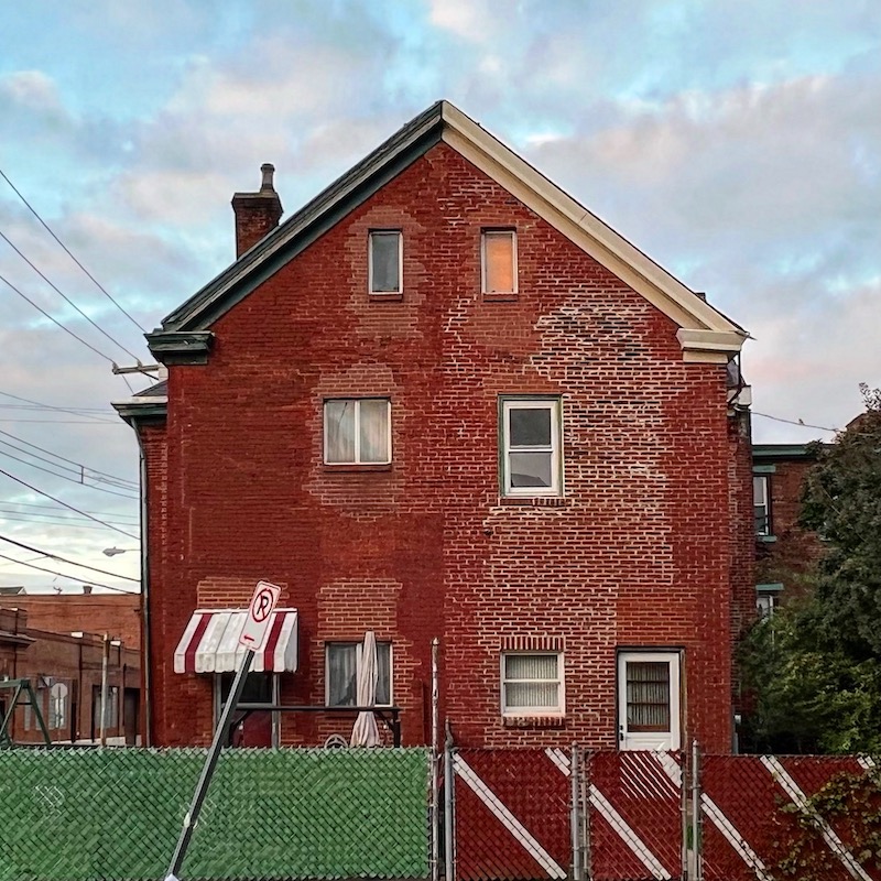 rear view of brick row house showing differences between two halves