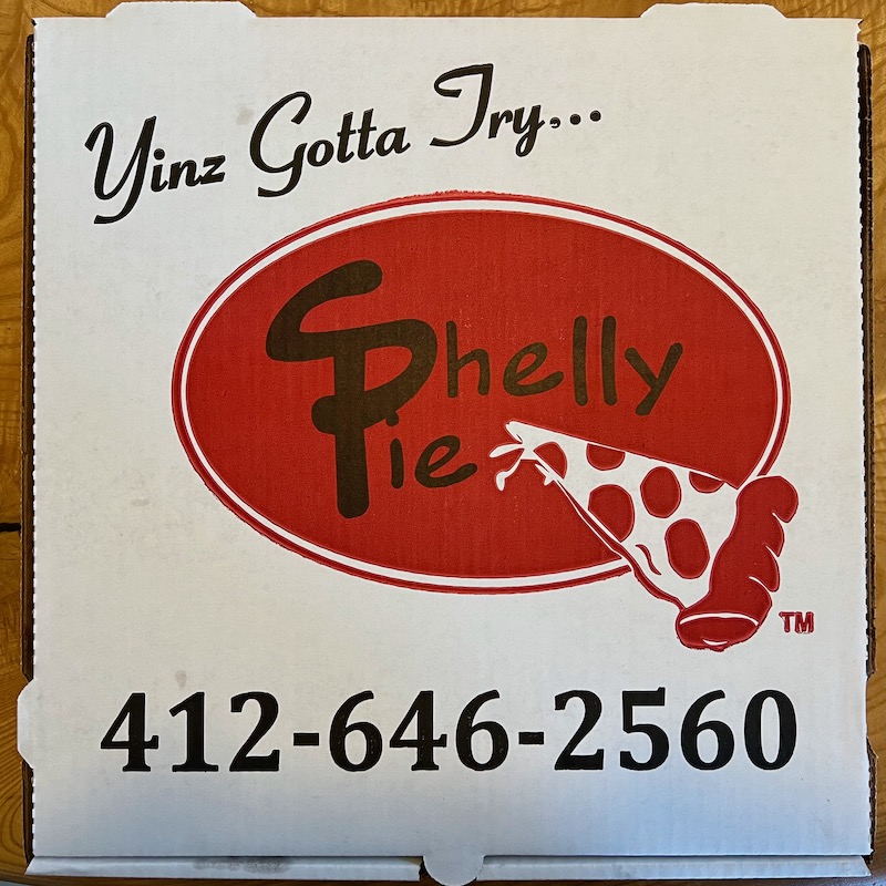 pizza box for Shelly Pie with catch phrase "Yinz gotta try ... Shelly Pie"