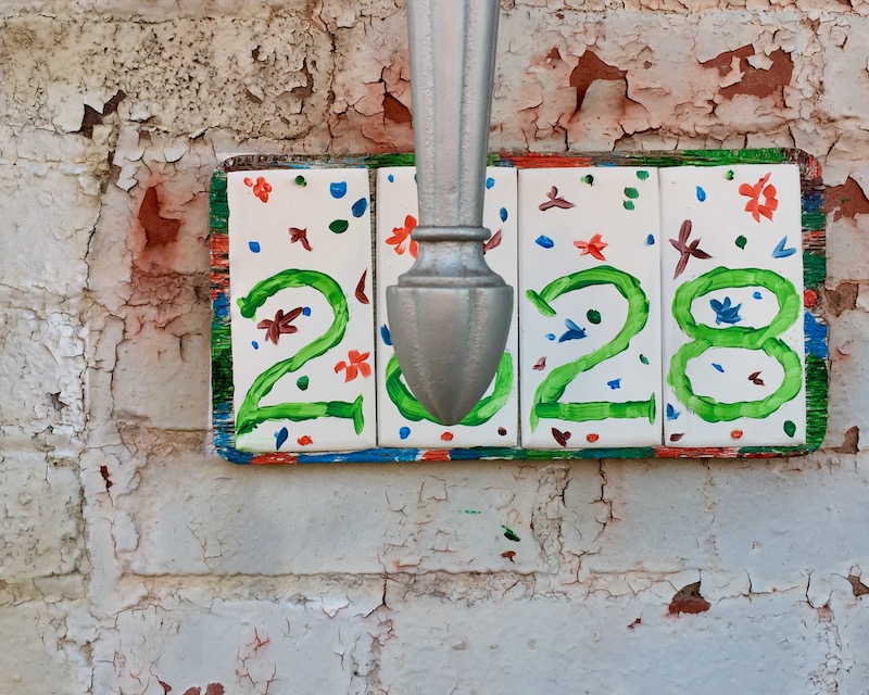 hand-painted residential address painted on ceramic tiles
