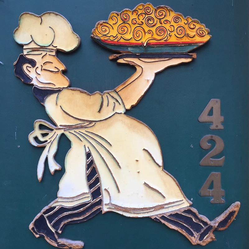 address for Italian Restaurant with image of chef carrying a large bown of pasta