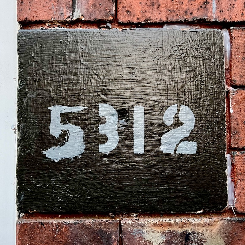 residential address number painted on masonry