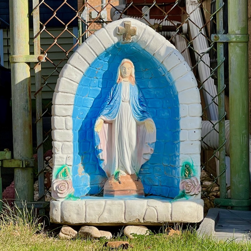 statue of Mary in front of house