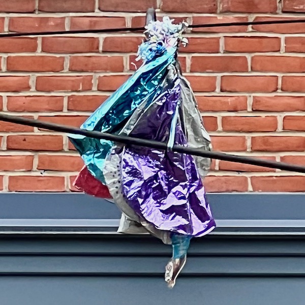 deflated balloons hanging from an electrical line