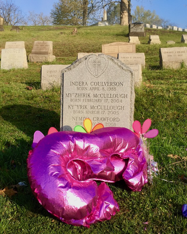 pink number balloons left by grave marker