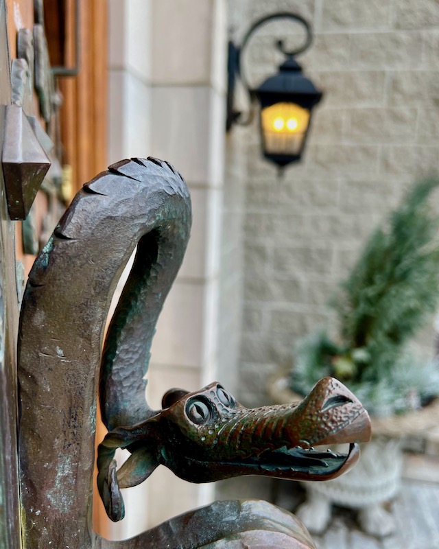 ornate bronze door handle in shape of dragon