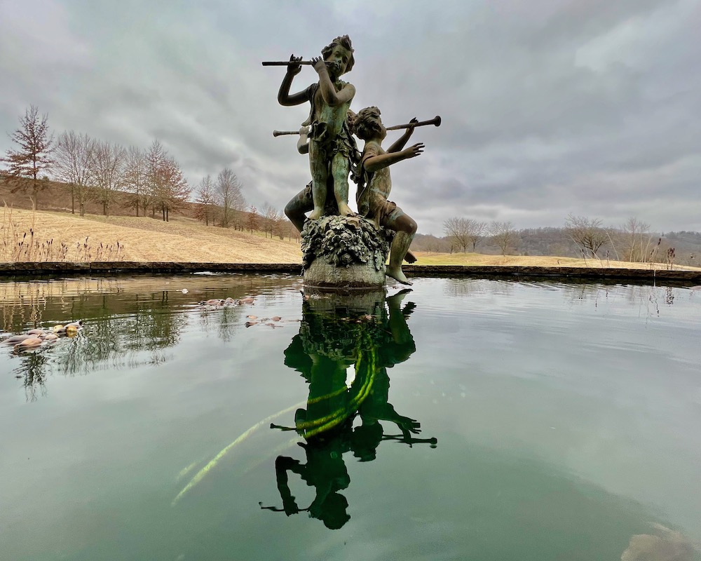 fountain with decorative cherubs under overcast sky