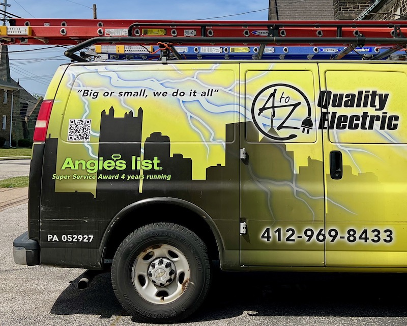 electrician's van decorated with stylized silhouette of downtown Pittsburgh skyline
