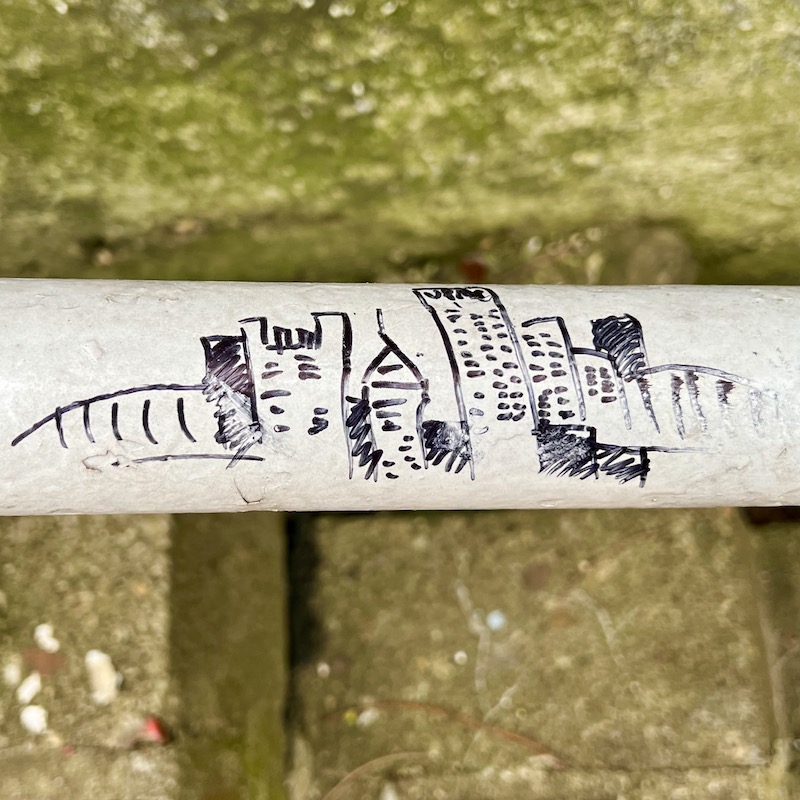 pen drawing of downtown Pittsburgh skyline drawn on handrail for public steps