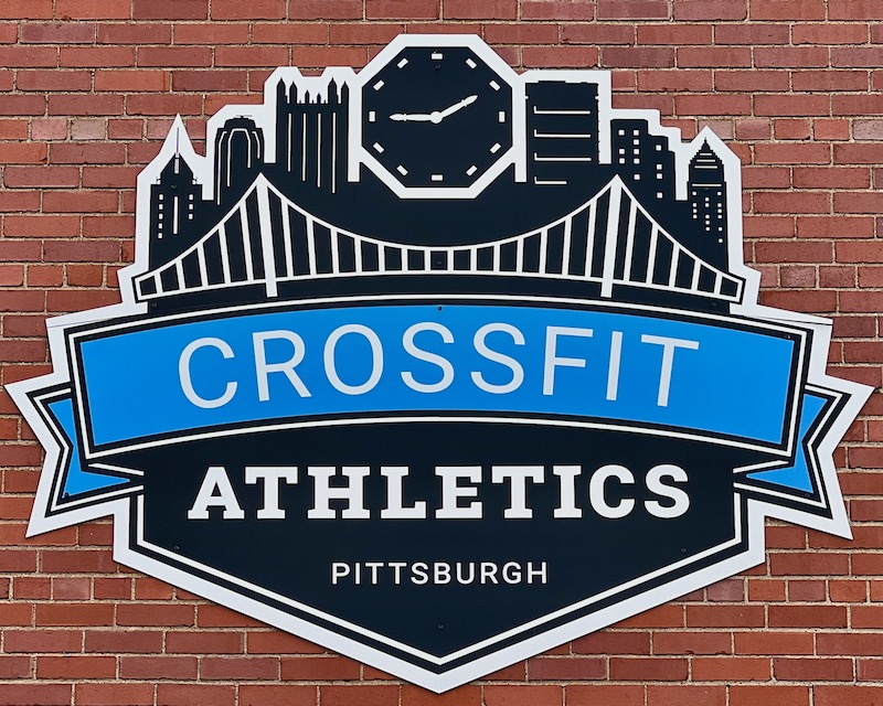 sign for gym featuring stylized image of downtown Pittsburgh