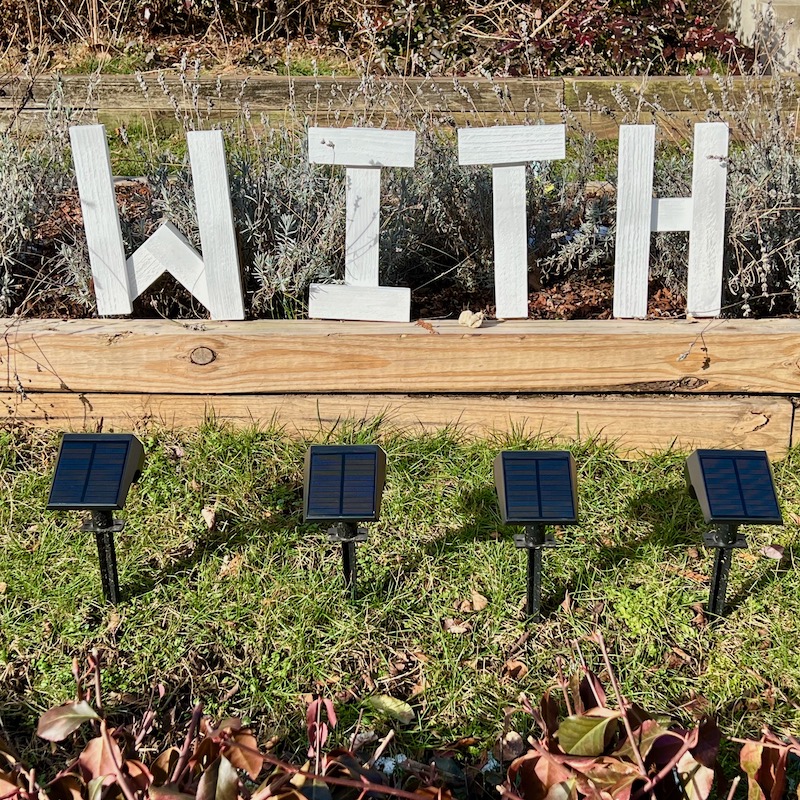 handmade letters attached to residential house reading "with"