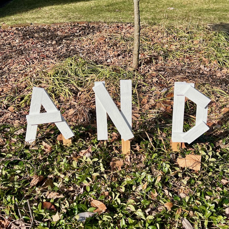 handmade letters attached to residential house reading "and"