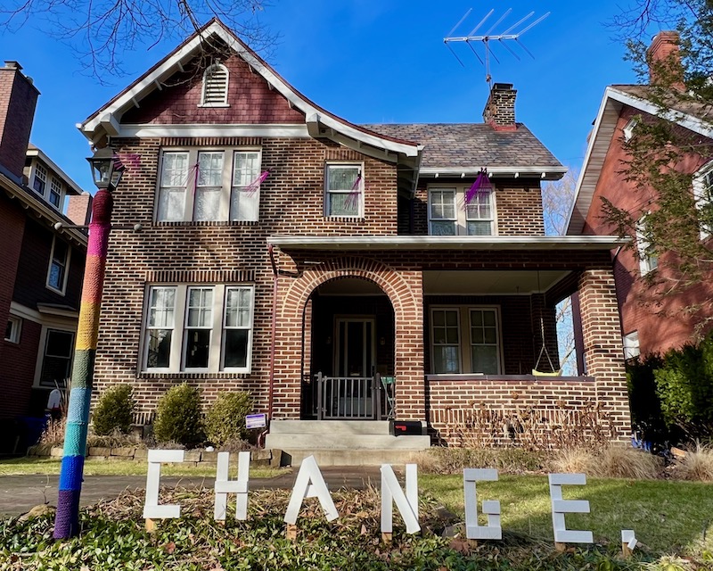 handmade letters attached to residential house reading "change"