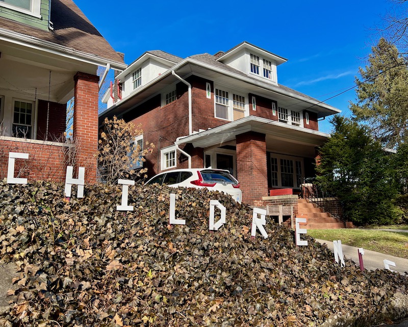 handmade letters attached to residential house reading "children's"