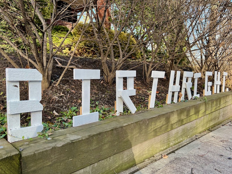 handmade letters attached to residential house reading "birthright"