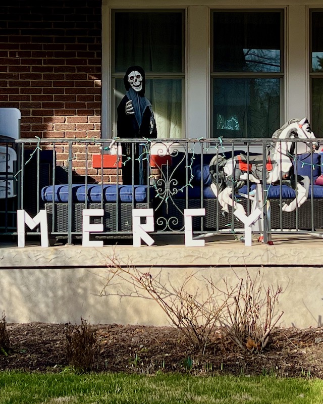 handmade letters attached to residential house reading "mercy"