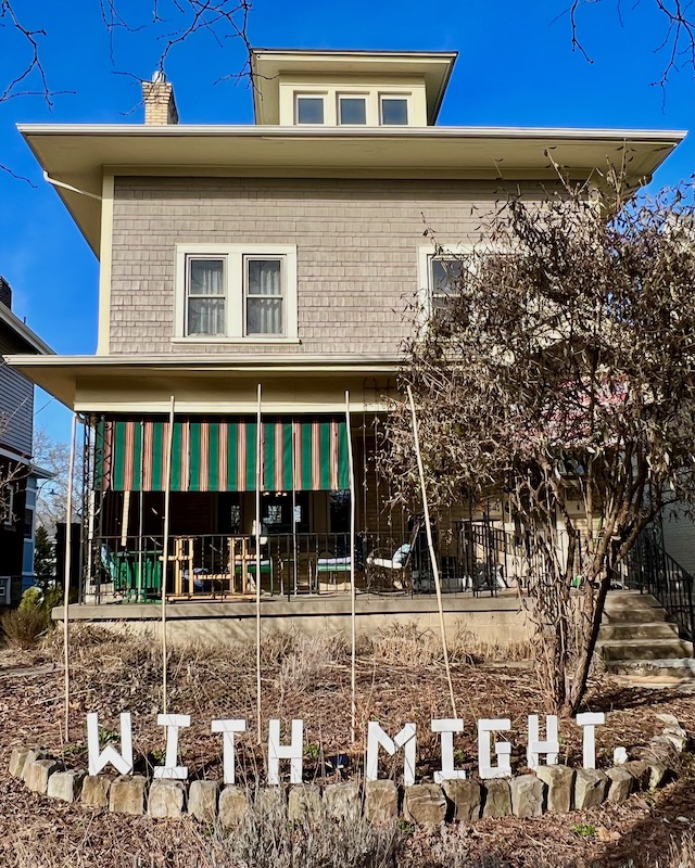 handmade letters attached to residential house reading "with might"