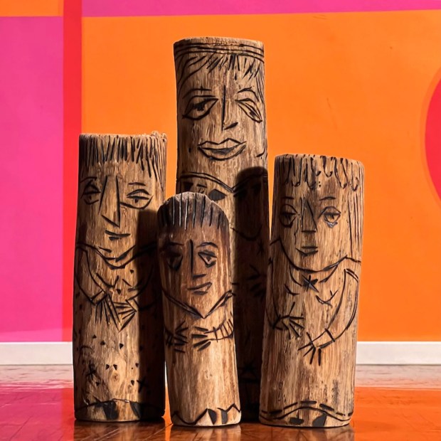 totem people created from burnt wood