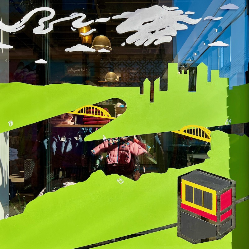 mural in shop window including skyline of downtown Pittsburgh