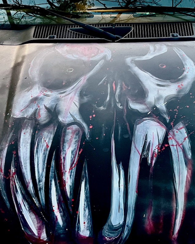 hood of car painted with skull and bloody fangs