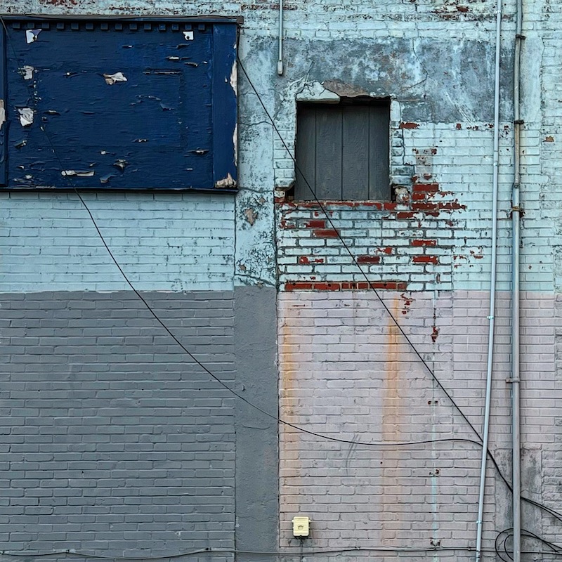 brick wall with many paint colors and textures