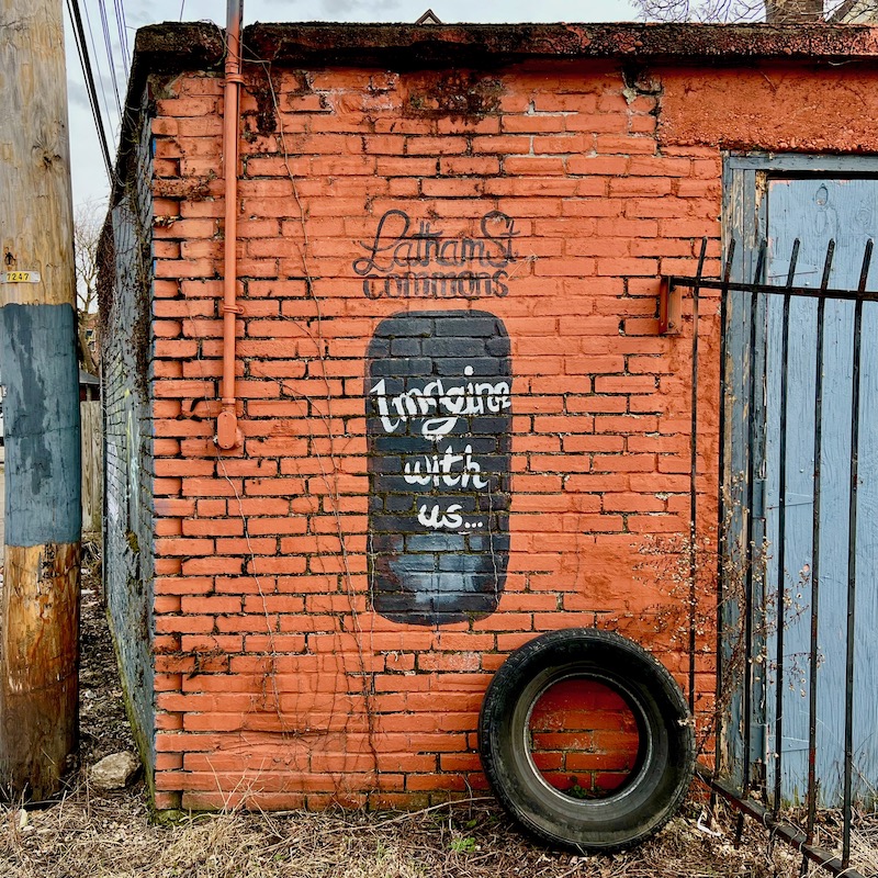 brick garage wall with small mural