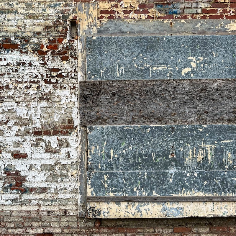 brick wall with layers of wood attached