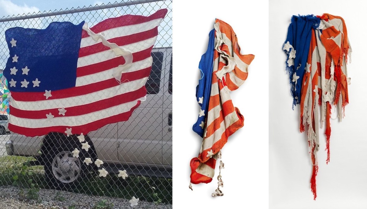 knitted artistic American flag hanging from chain link fence