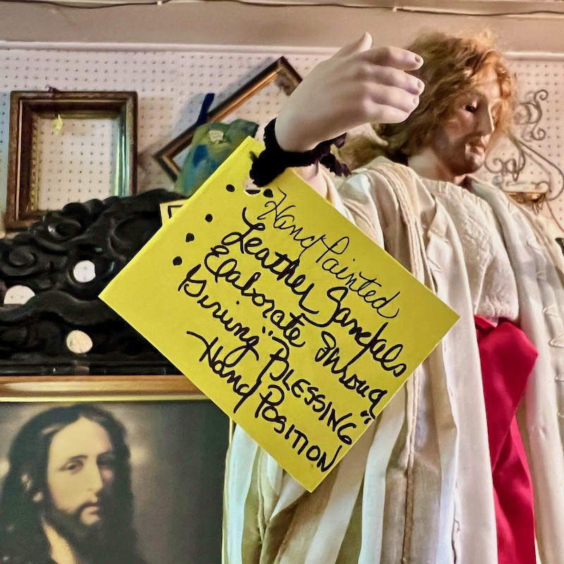 Jesus statue in antique store with hand-written sales tag