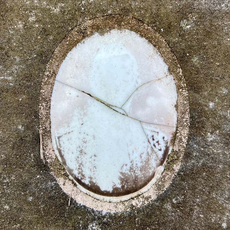 ceramic photo grave marker inset of photo so faded as to appear ghostly
