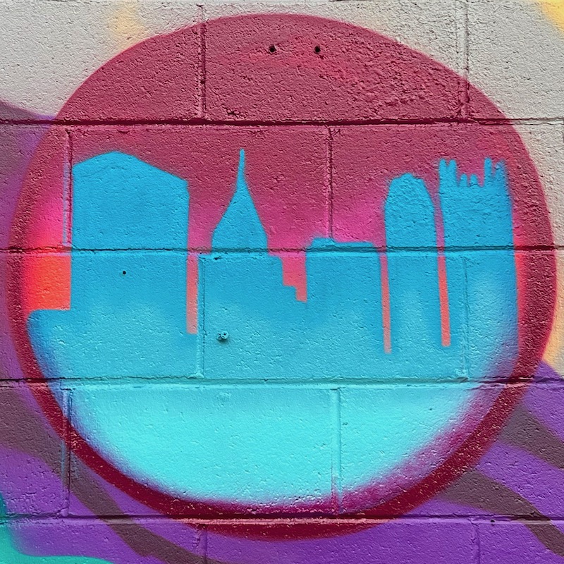 spray-painted mural including skyline of downtown Pittsburgh inside a bubble