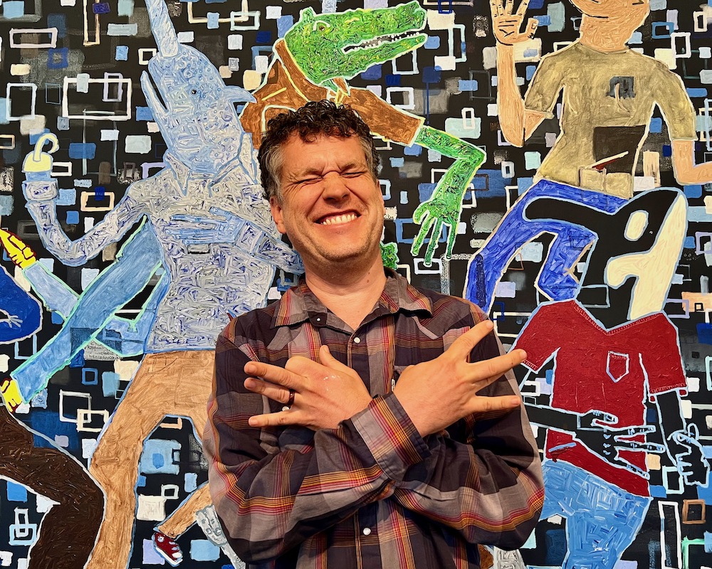 artist John Lee in front of large painting