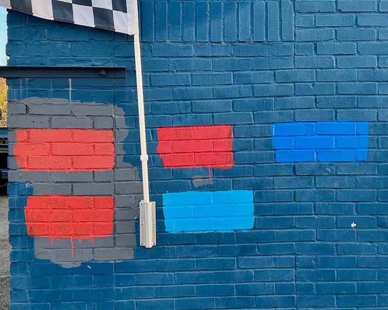 paint swatch test on brick wall